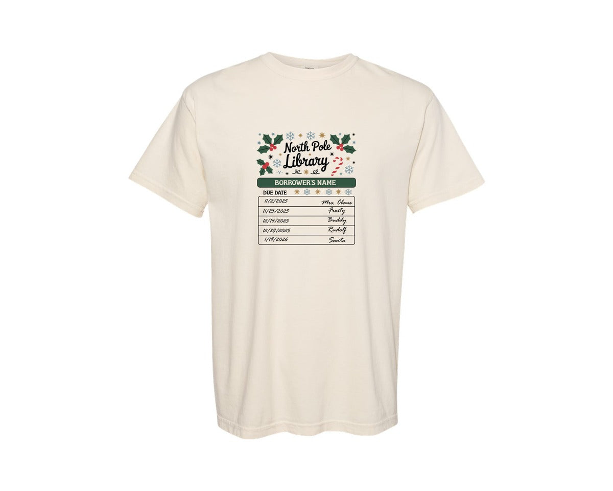 brand:Comfort Colors|color:Ivory|North Pole Library Bookish Xmas Graphic T-Shirt