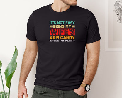 brand:Bella Canvas|color:Black|Its Not Easy Being My Wifes Arm Candy 31 Graphic T-Shirt