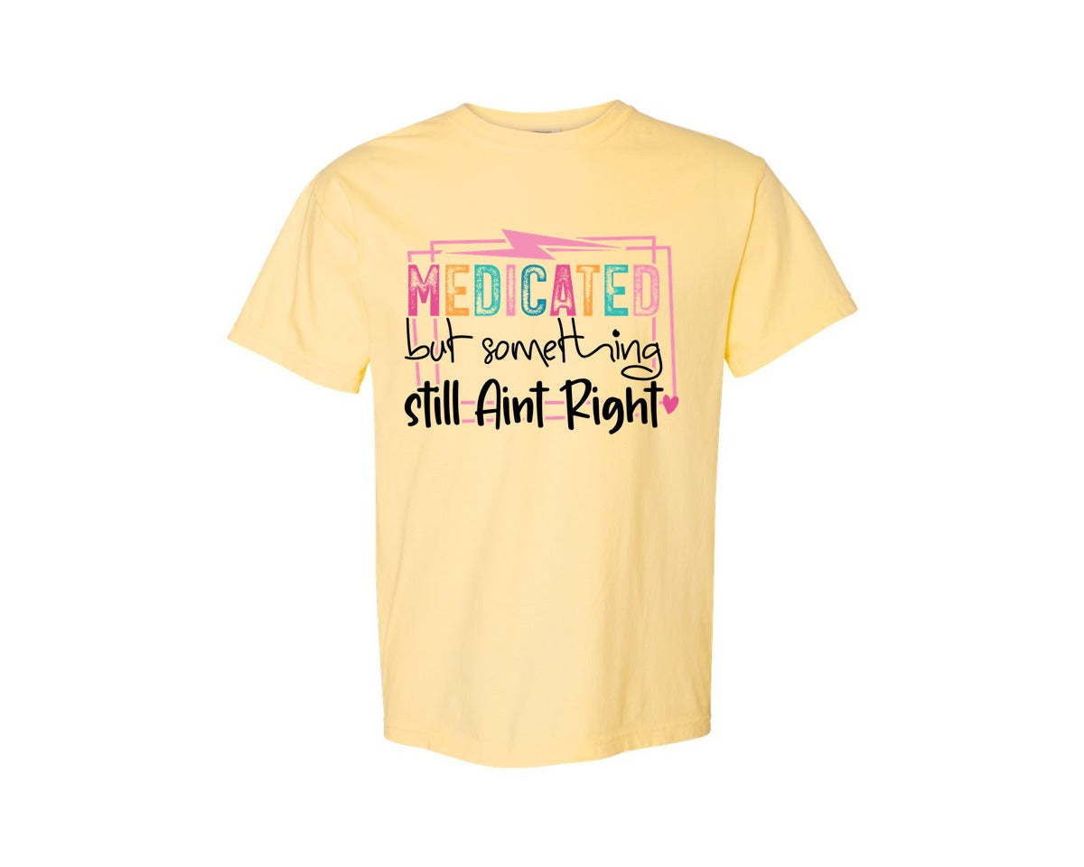 brand:Comfort Colors|color:Butter|Medicated But Somethin Aint Right Snarky Graphic T-Shirt