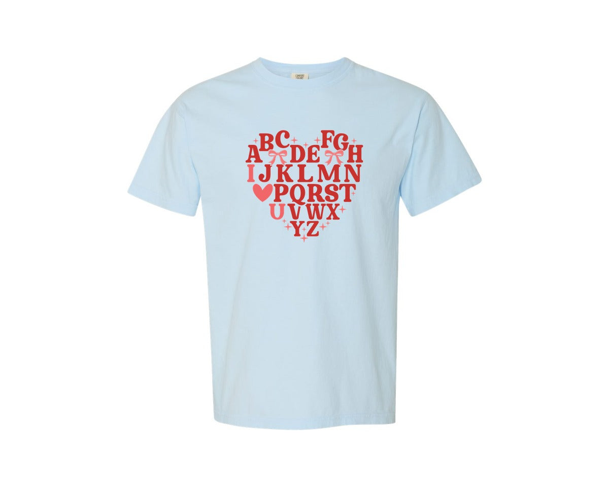 brand:Comfort Colors|color:Chambray|Teacher Alphabet Valentine Bow Graphic T-Shirt