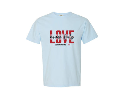 brand:Comfort Colors|color:Chambray|Love Never Fails Svgfaith Valentine Graphic T-Shirt