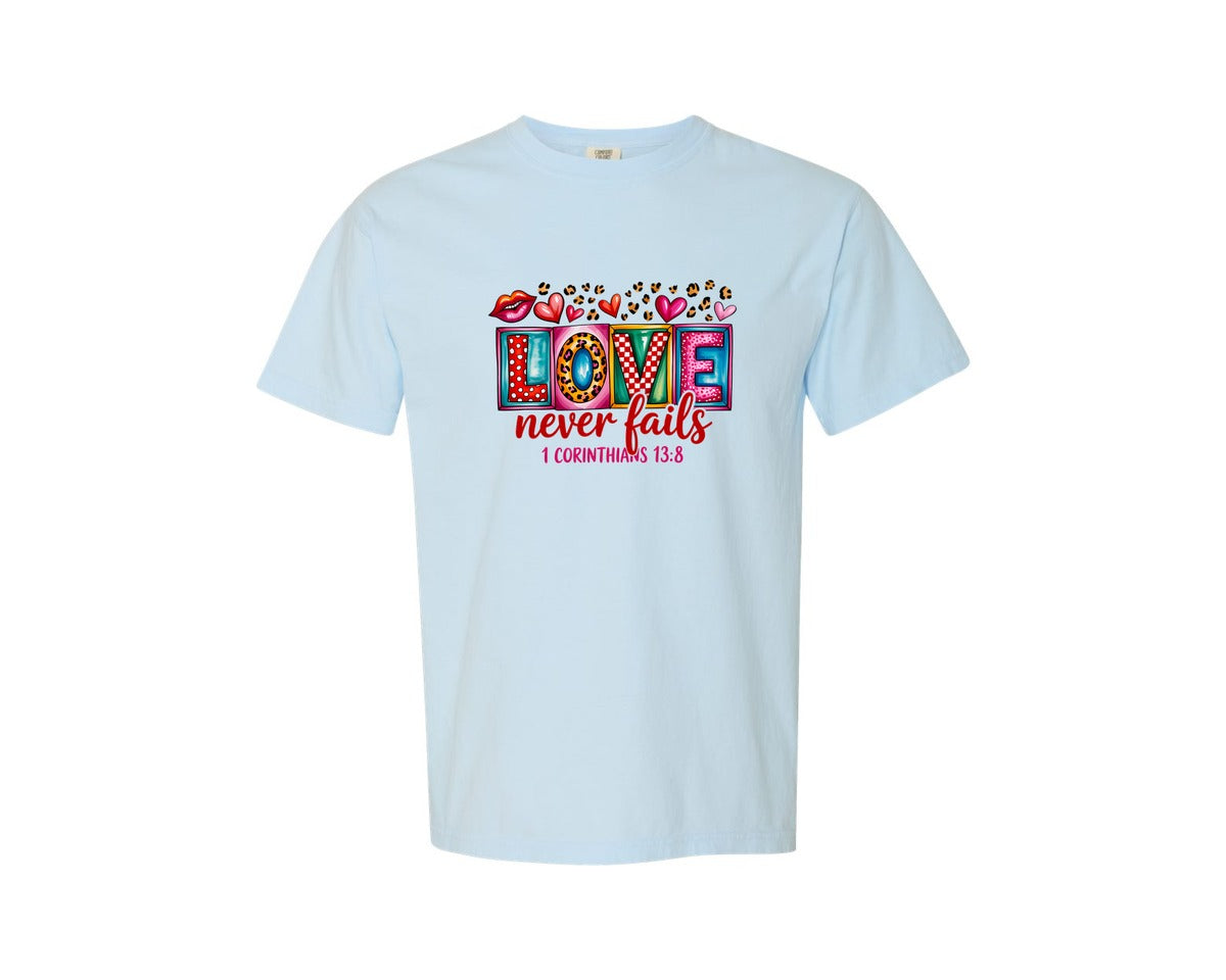 brand:Comfort Colors|color:Chambray|Love Never Fails 1 Corinthians 138 Graphic T-Shirt