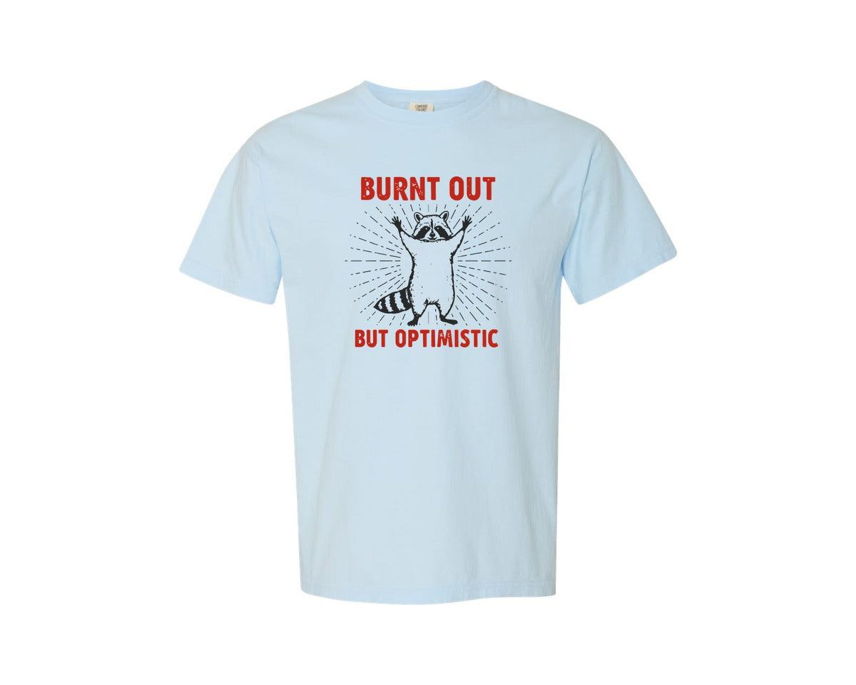 brand:Comfort Colors|color:Chambray|Burnt Out But Optimistic Raccoon Graphic T-Shirt