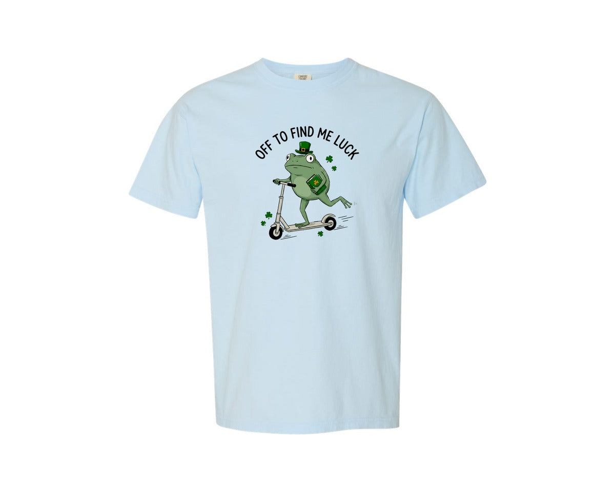 brand:Comfort Colors|color:Chambray|Off To Find Me Luck Frog Scooter Graphic T-Shirt