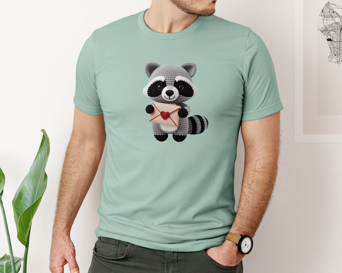 brand:Bella Canvas|color:Dusty Blue|Crochet Raccoon Holding Love Letter Graphic T-Shirt