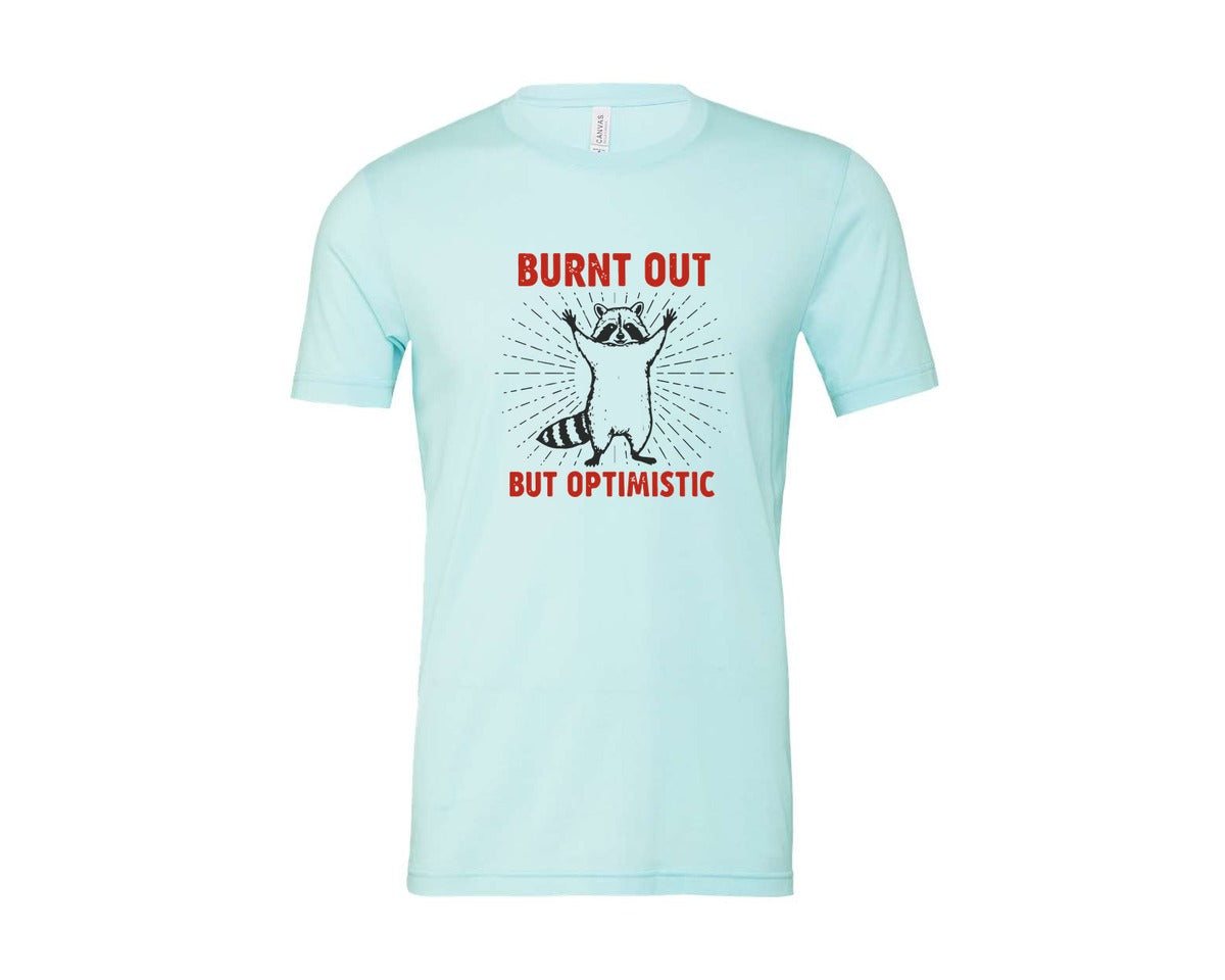 brand:Bella Canvas|color:Heather Ice Blue|Burnt Out But Optimistic Raccoon Graphic T-Shirt