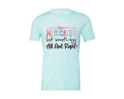 brand:Bella Canvas|color:Heather Ice Blue|Medicated But Somethin Aint Right Snarky Graphic T-Shirt