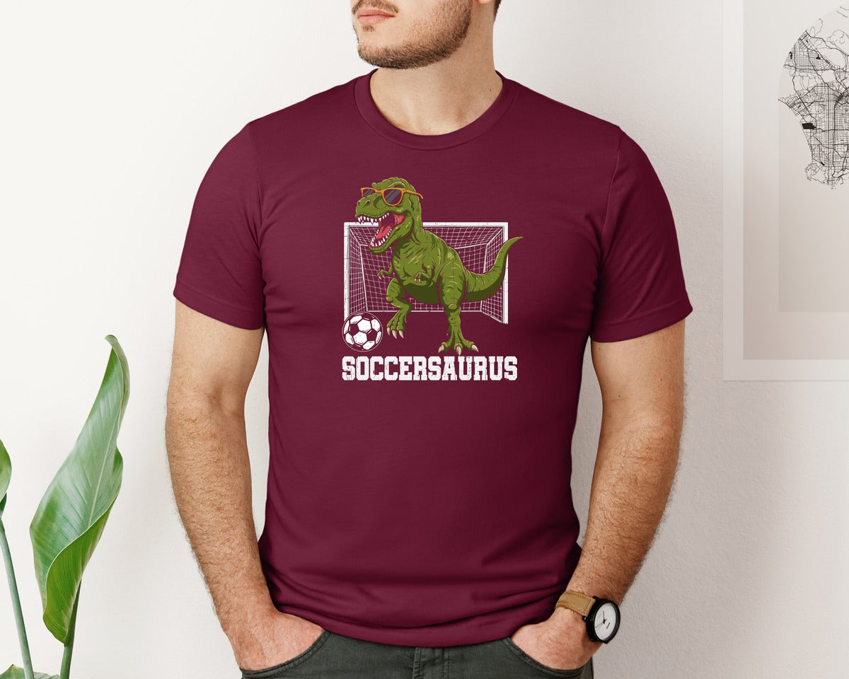 brand:Bella Canvas|color:Heather Maroon|T Rex Playing Soccer T Shirt Graphic T-Shirt