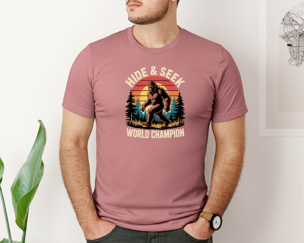 brand:Bella Canvas|color:Heather Mauve|Funny Bigfoot Hide Seek Champion Graphic T-Shirt