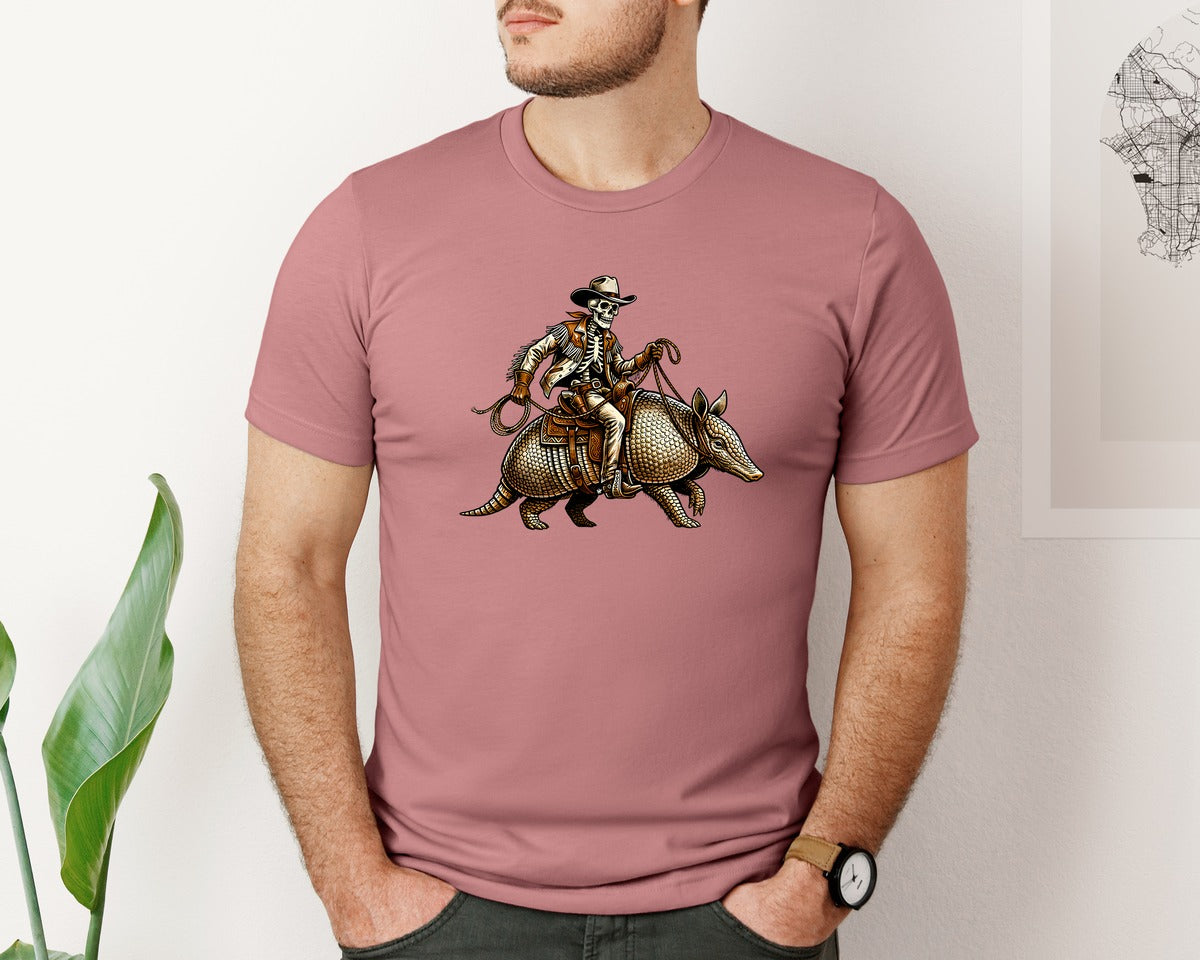 brand:Bella Canvas|color:Heather Mauve|Cowboy Skeleton Riding Armadillo Graphic T-Shirt