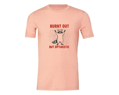 brand:Generic|color:Heather Peach|Burnt Out But Optimistic Raccoon Graphic T-Shirt