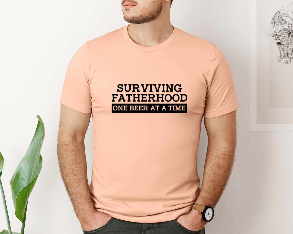 brand:Bella Canvas|color:Heather Peach|Surviving Fatherhood Mens T Shirt Graphic T-Shirt