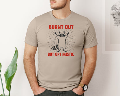 brand:Bella Canvas|color:Heather Tan|Burnt Out But Optimistic Raccoon Graphic T-Shirt