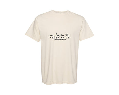 brand:Comfort Colors|color:Ivory|Love Never Fails Svgvalentine Faith Graphic T-Shirt