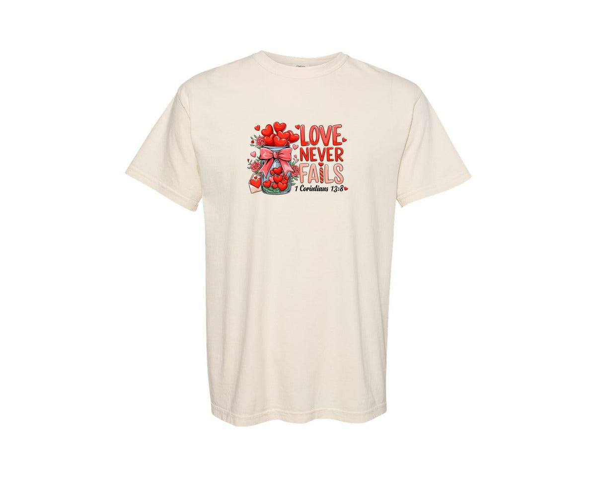 brand:Comfort Colors|color:Ivory|Love Never Fails Valentine Graphic T-Shirt