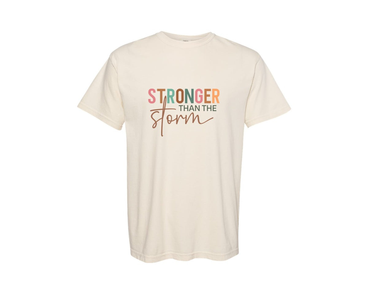 brand:Comfort Colors|color:Ivory|Stronger Than The Storm Bible Verse Graphic T-Shirt