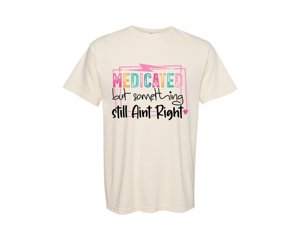 brand:Comfort Colors|color:Ivory|Medicated But Somethin Aint Right Snarky Graphic T-Shirt