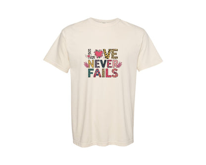brand:Comfort Colors|color:Ivory|Love Never Fails Trendy Valentines Graphic T-Shirt