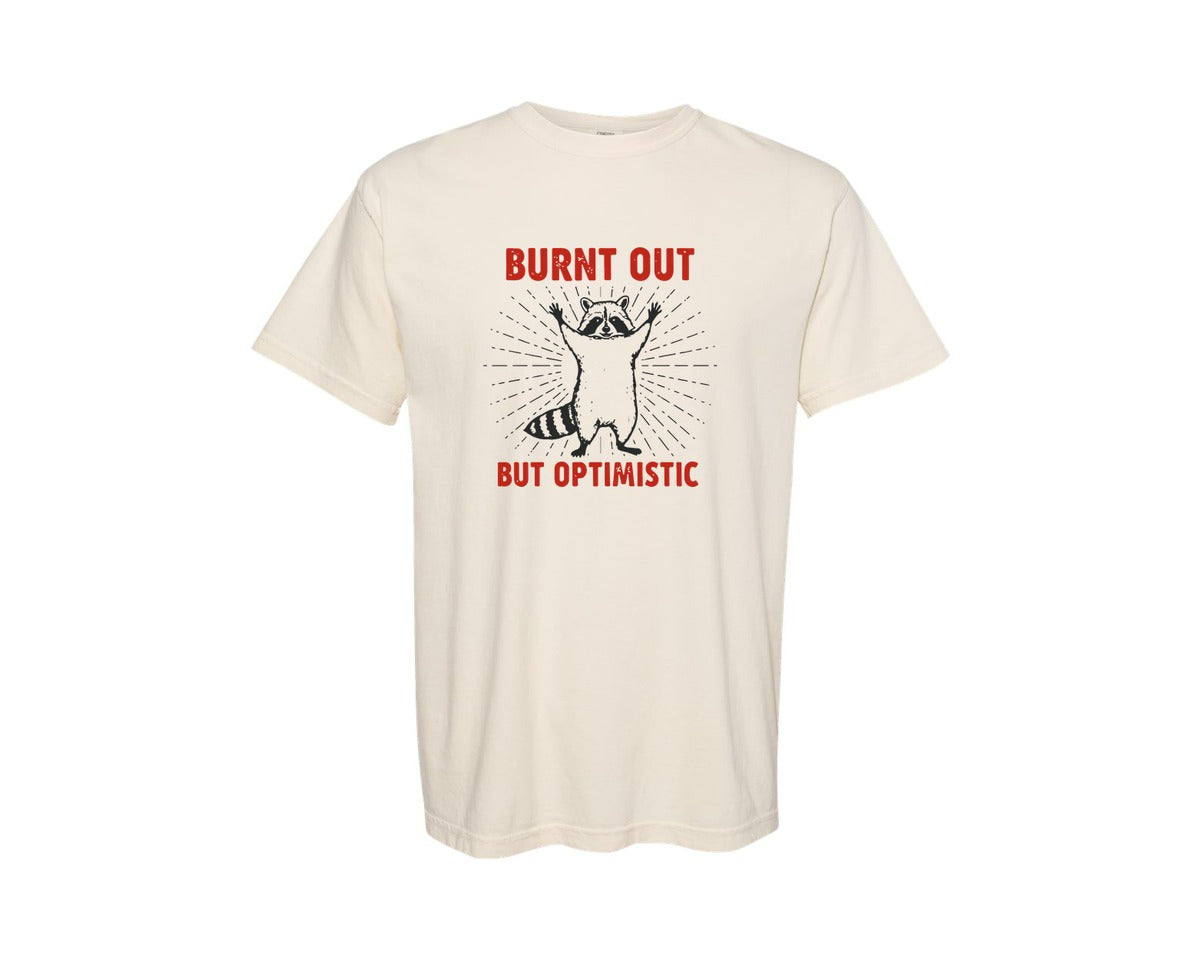 brand:Comfort Colors|color:Ivory|Burnt Out But Optimistic Raccoon Graphic T-Shirt