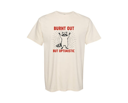 brand:Comfort Colors|color:Ivory|Burnt Out But Optimistic Raccoon Graphic T-Shirt