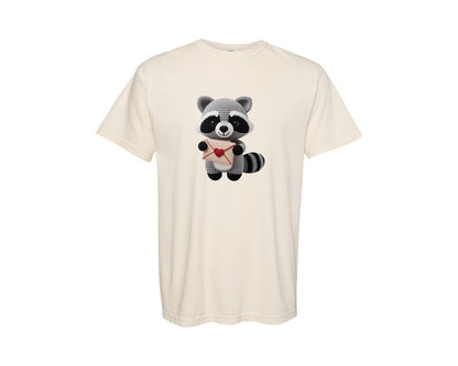 brand:Comfort Colors|color:Ivory|Crochet Raccoon Holding Love Letter Graphic T-Shirt