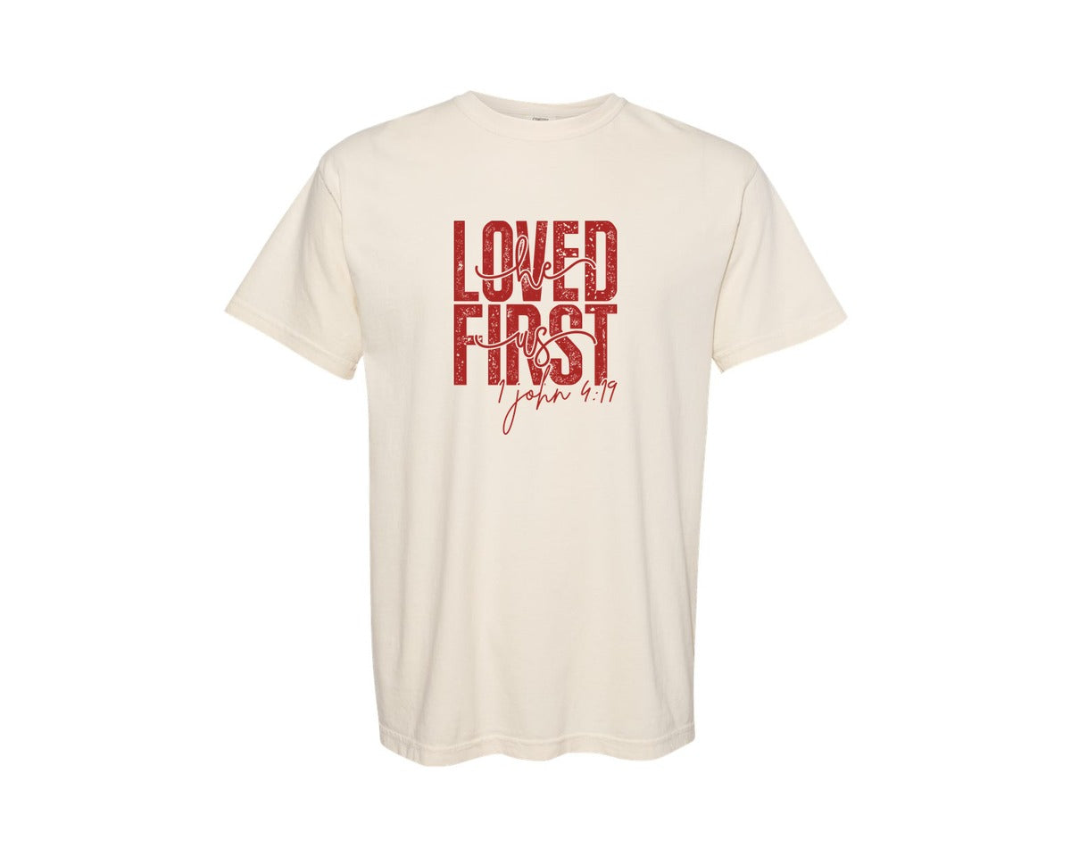brand:Comfort Colors|color:Ivory|He Loved Us First 1 John 419 4 Graphic T-Shirt