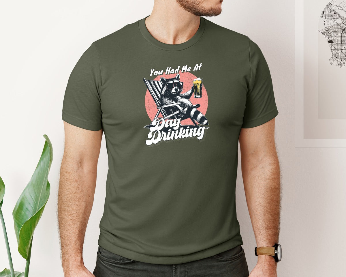 brand:Bella Canvas|color:Military Green|You Had Me At Day Drinking Raccoon Shirt Graphic T-Shirt