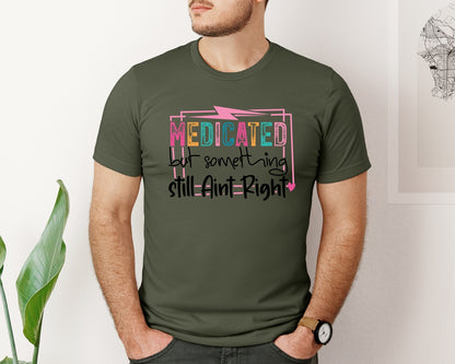 brand:Bella Canvas|color:Military Green|Medicated But Somethin Aint Right Snarky Graphic T-Shirt