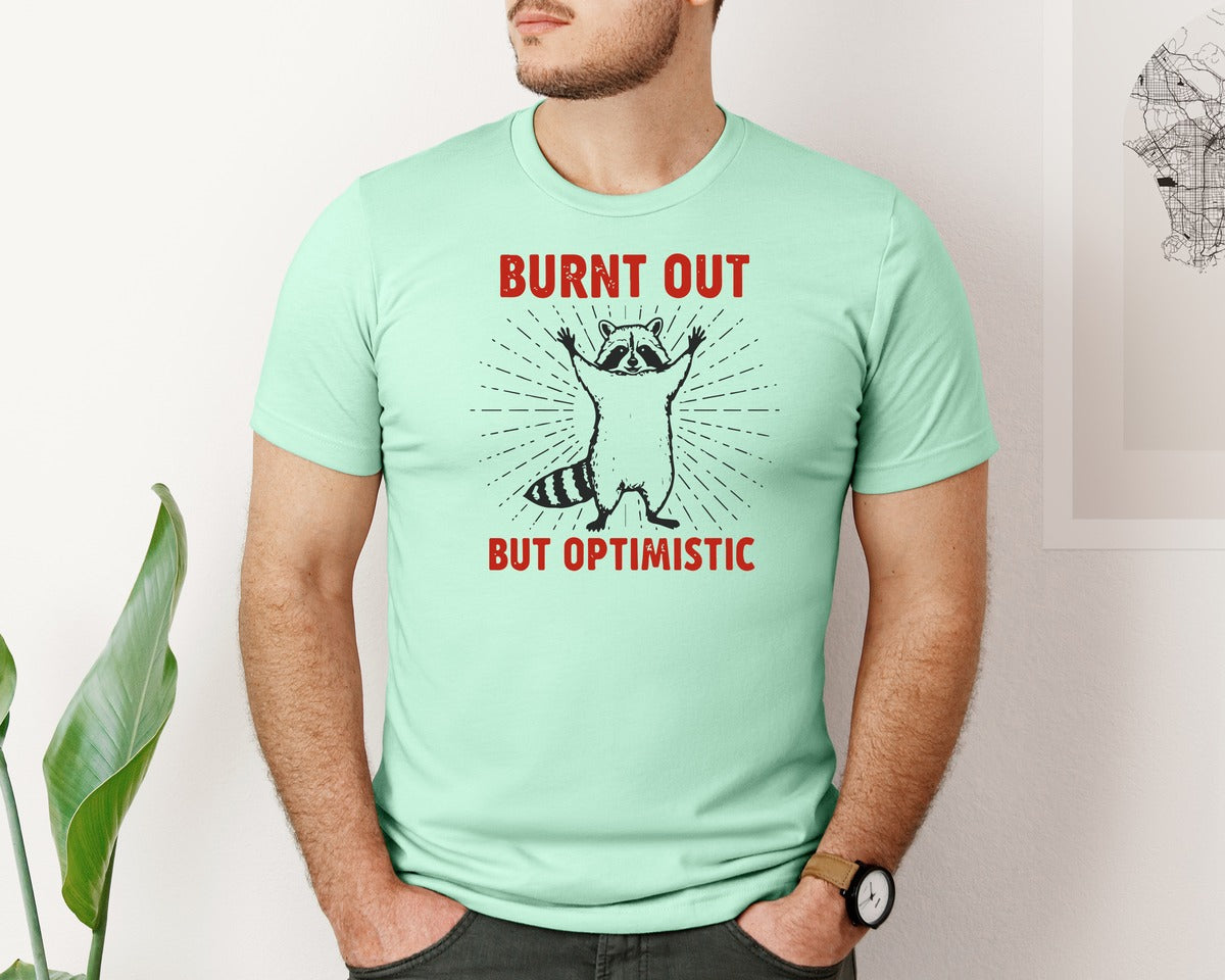 brand:Bella Canvas|color:Mint|Burnt Out But Optimistic Raccoon Graphic T-Shirt