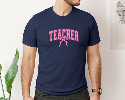 brand:Bella Canvas|color:Navy|Teacher Coquette Pink Bow Teach Varsity Graphic T-Shirt