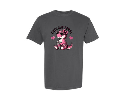 brand:Comfort Colors|color:Pepper|Cute But Feral Baby Girl Dinosaur Graphic T-Shirt
