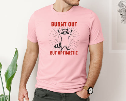brand:Bella Canvas|color:Pink|Burnt Out But Optimistic Raccoon Graphic T-Shirt