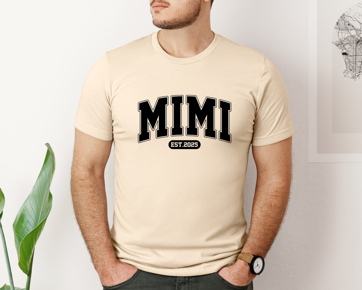 brand:Bella Canvas|color:Soft Cream|Mimi Est 2025 Retro Varsity Graphic T-Shirt