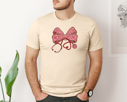 brand:Bella Canvas|color:Soft Cream|Valentine Nurse Stethoscope Coquette Bow Graphic T-Shirt