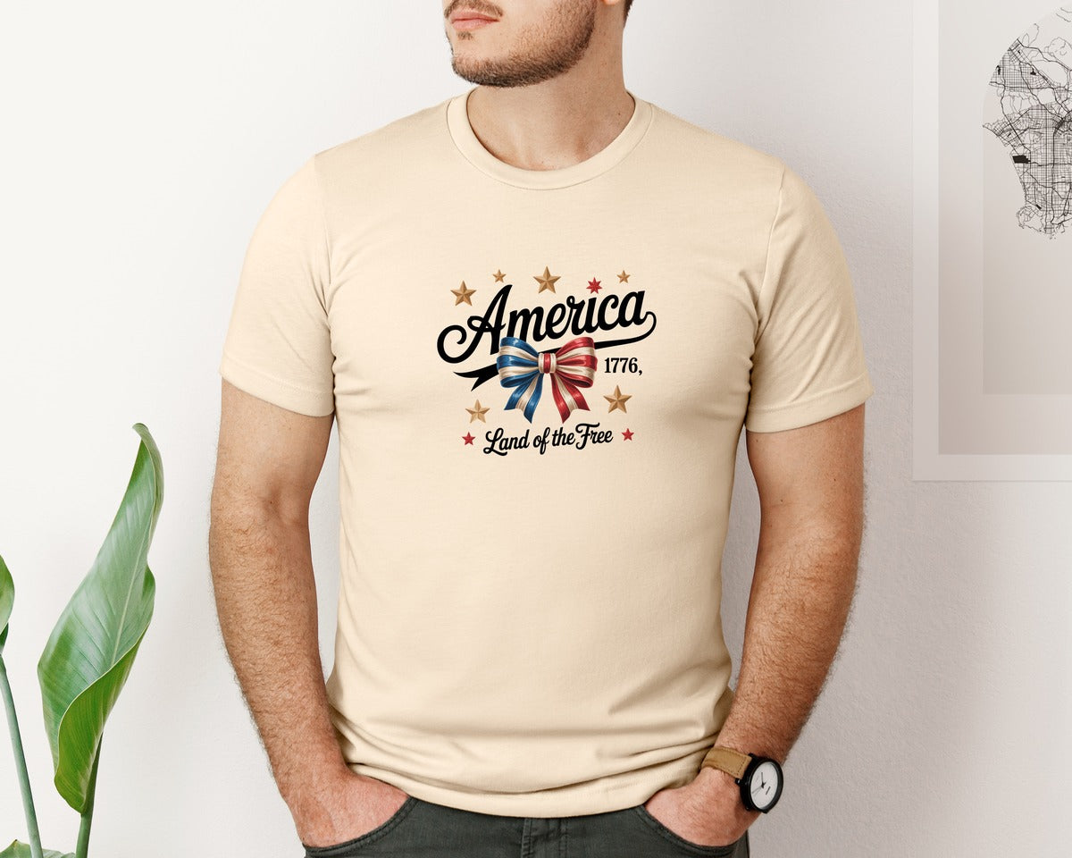 brand:Bella Canvas|color:Soft Cream|Patriotic Ribbon Bow With Gold Stars Graphic T-Shirt