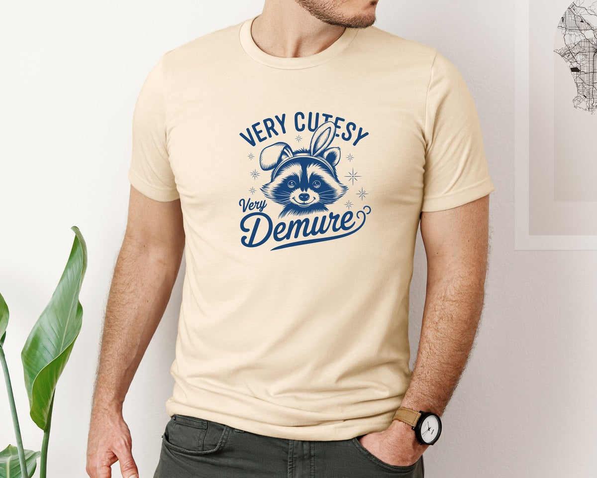brand:Bella Canvas|color:Soft Cream|Very Cutesy Very Demure Raccoon T Shirt Graphic T-Shirt