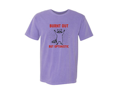 brand:Comfort Colors|color:Violet|Burnt Out But Optimistic Raccoon Graphic T-Shirt
