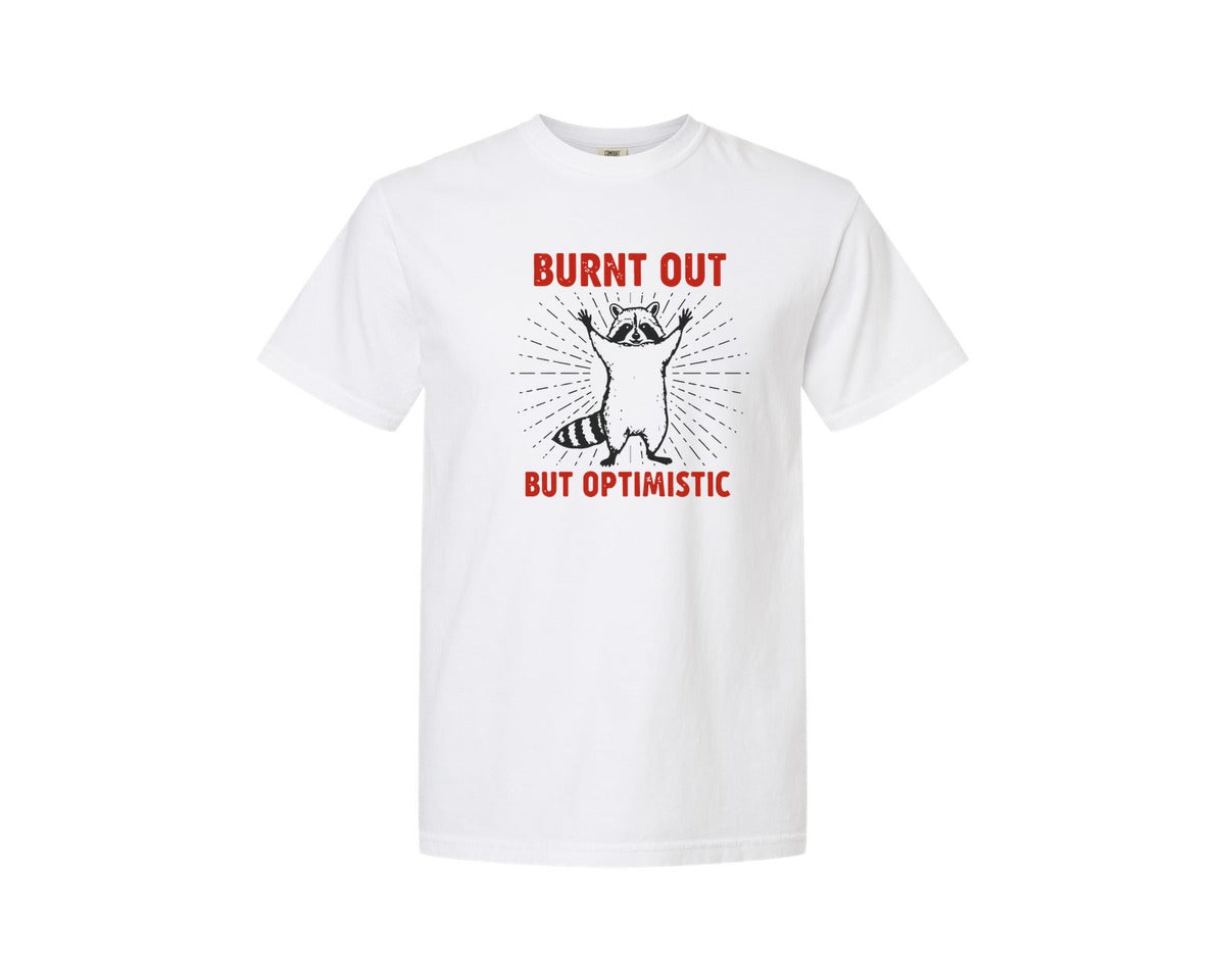 brand:Comfort Colors|color:White|Burnt Out But Optimistic Raccoon Graphic T-Shirt