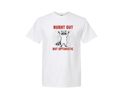 brand:Comfort Colors|color:White|Burnt Out But Optimistic Raccoon Graphic T-Shirt
