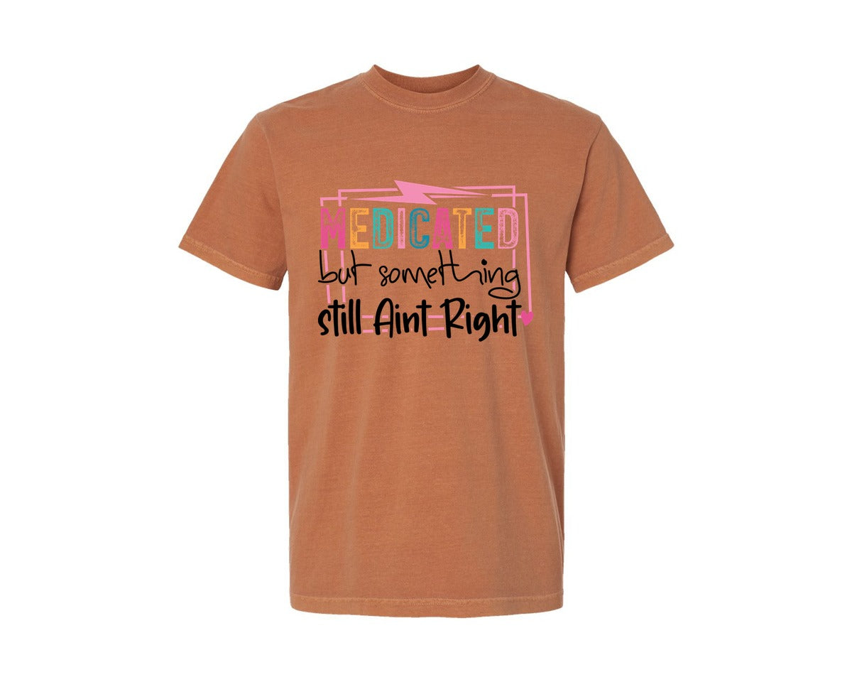 brand:Comfort Colors|color:Yam|Medicated But Somethin Aint Right Snarky Graphic T-Shirt