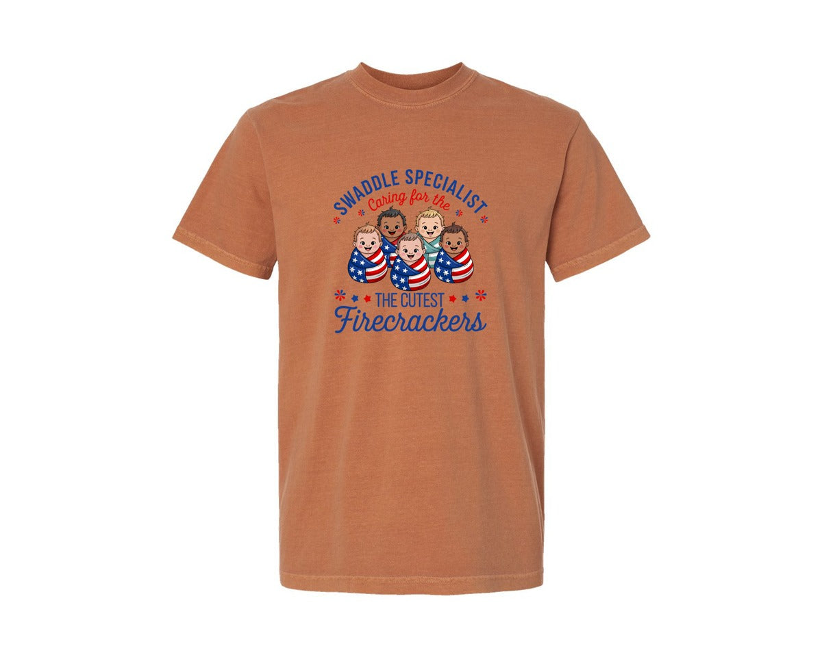 brand:Comfort Colors|color:Yam|Swaddle Specialist 4Th Of July Babies Graphic T-Shirt