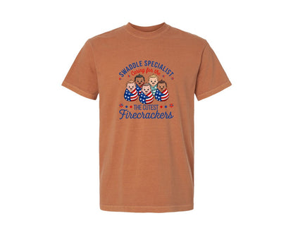 brand:Comfort Colors|color:Yam|Swaddle Specialist 4Th Of July Babies Graphic T-Shirt