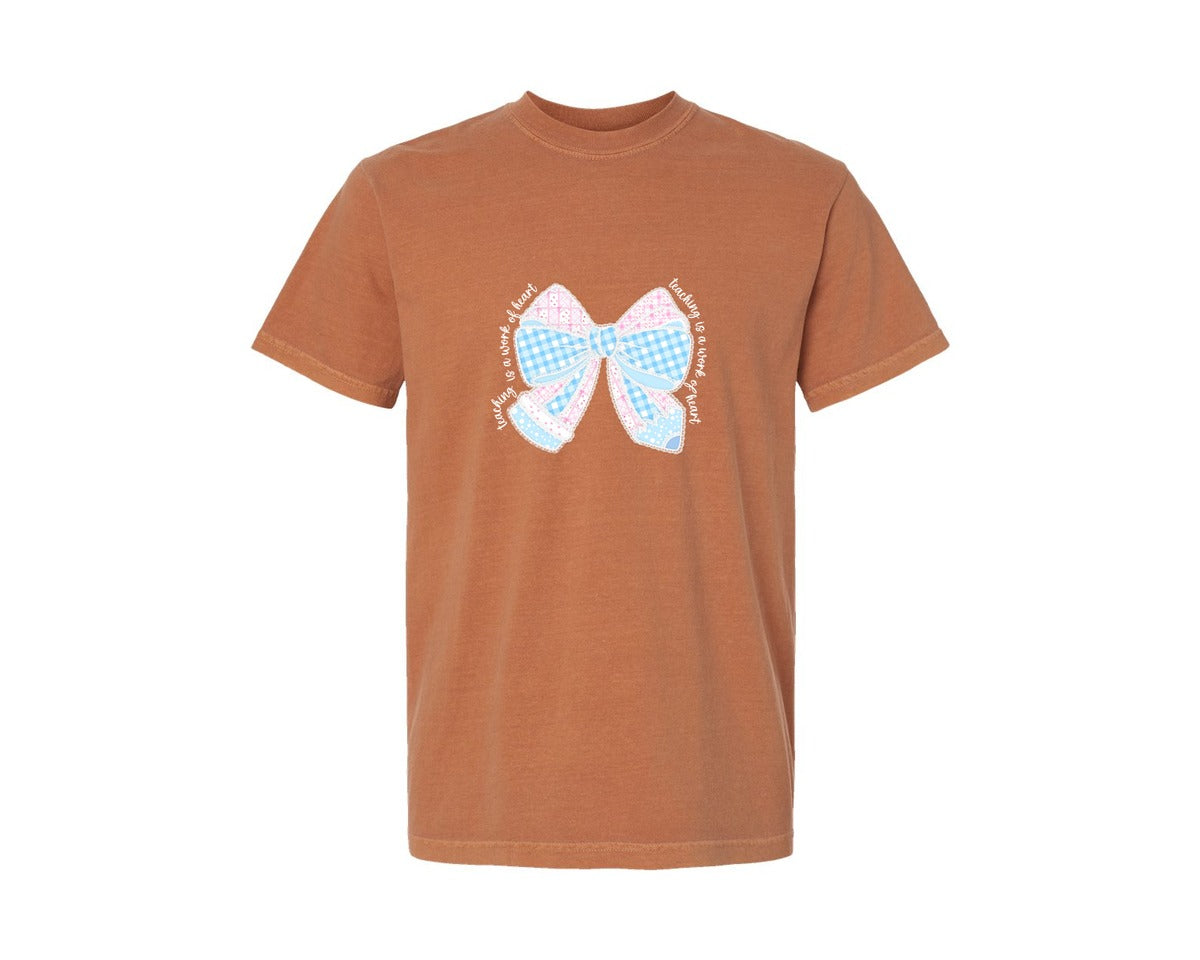 brand:Comfort Colors|color:Yam|Teaching Is A Work Of Heart Bow Graphic T-Shirt